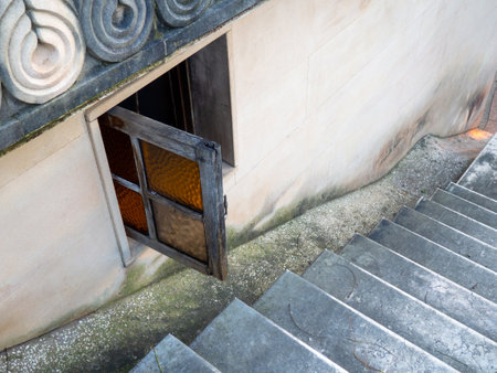 Open window at the stairs. Old window in the church. Quiet cozy place. Staircase at the church. Architecture. The concept of an open windowの写真素材
