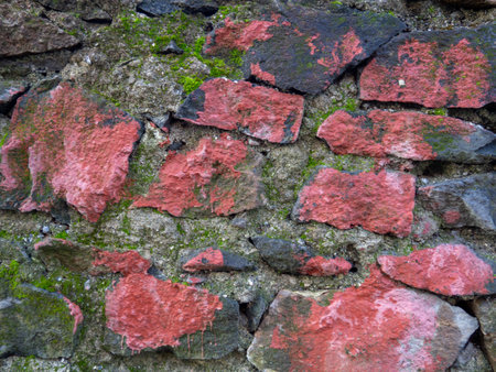 Vintage masonry red stone. Old wall made of rough stones. Background of solid red material. ancient architectureの写真素材