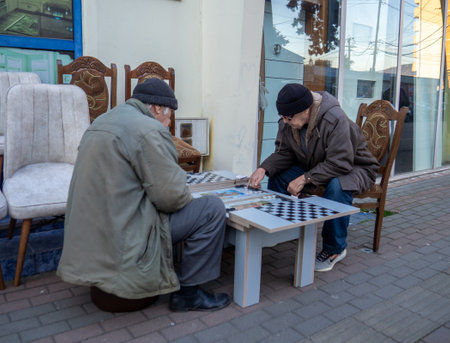 Batumi, Georgia. 18/01/2023 Men play backgammon in the street. People behind the intellectual game. Time spent in retirementのeditorial素材