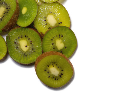 Round kiwi slices on a white background. The concept of juicy ripe fruit. Place for an inscription. Mockup. raw food diet.Ingredient for many dishes. Southern fruit. Ripens in winterの写真素材