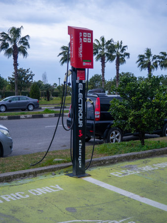 Batumi, Georgia. 01.28.2023 Device for charging electric vehicles. city infrastructure. modern city. electric car. Electric car parking. Caring for the environment. in the parkingの写真素材