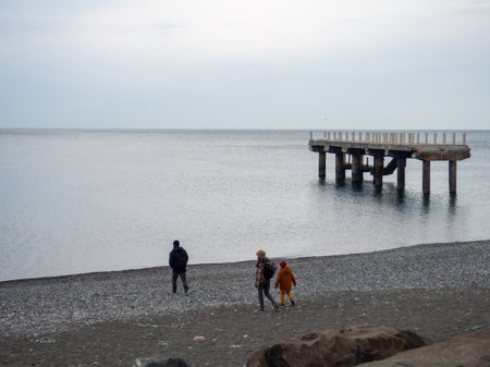 People are walking along the pier. Cold season at the resort. Not a season. broken pierの写真素材