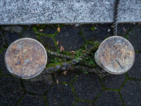 rope goes into the water from the bollard. Attaching boats to the pier. Port area. Sea port. stretched rope.の写真素材