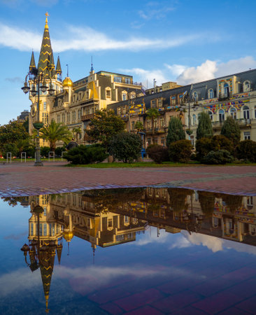 Landmark of Batumi in the reflection of a puddle. Europe Square. Architecture of Georgia. City Park. Winter at the seaside resort. Streetsの写真素材