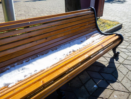 Snow on a park bench. Winter in Batumi. Winter at the resort. Southern City . Sudden snowfall. Contrastの写真素材