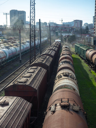Batumi, Georgia. 02.25.2023 Loading area of the station. Lots of freight trains. Wagons - tanks on rails. Fuel export. Smoke in the industrial zoneのeditorial素材