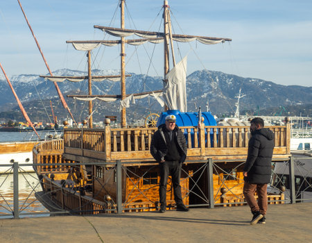 Batumi, Georgia. 02.25.2023 Captain at his ship. A man in a captain's hat. The ship is made under the old.のeditorial素材