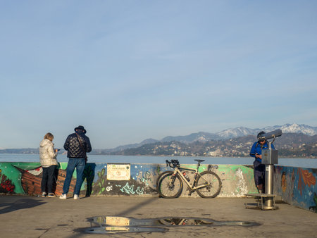 Batumi, Georgia. 02.25.2023 people on the embankment. Vacation at the sea. Batumiのeditorial素材