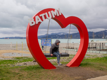 Batumi, Georgia. 02.10.2023 I love Batumi. Place for photo tourists. Swing in the heart. Beautiful place. At the resort in winterのeditorial素材