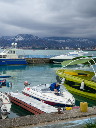 Batumi, Georgia. 02.10.2023 Ship at the pier. Winter season. Not a season. Lack of tourists. Ship repair concept. Shipyard. The yacht is afloat. Batumi port.Mainly cloudyのeditorial素材