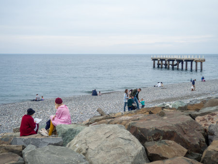 Batumi, Georgia. 03.11.2023 People rest on the seashore in cold weather. Not a season. Black Sea. People on the coast. Holidays for the whole familyのeditorial素材