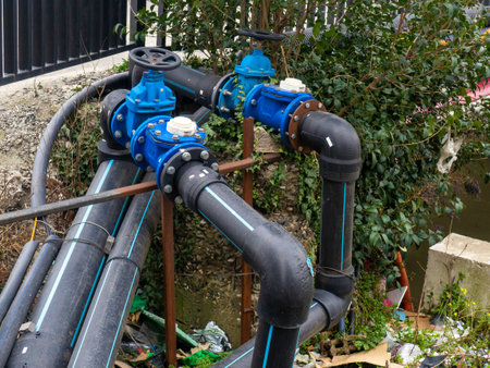 Gas pipes with valves on the street. Communications in the city. Gas pipeline on the street. Black pipes. Gas supply conceptの写真素材