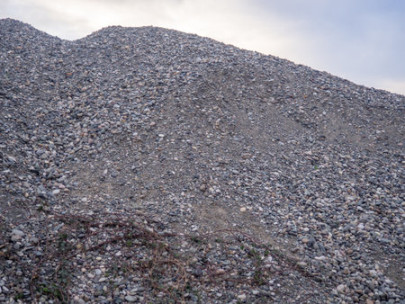 Mountains of rubble. Gray background. Construction material. Crushed stone for road construction. stones for laying under the asphalt. Lots of cobblestonesの写真素材