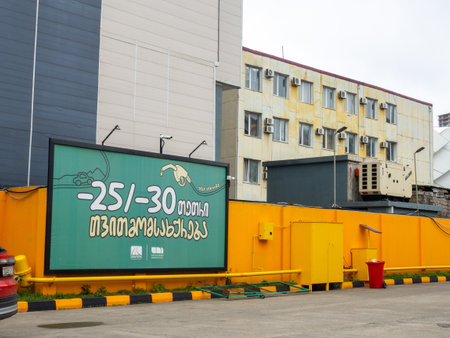 Batumi, Georgia. 03.18.2023 Street advertising in the industrial area. Colorful billboard. in Georgianのeditorial素材