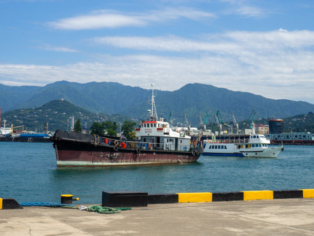 Ships in the bay. A fishing trawler enters the port. Sea transport. Industry. In the Black Sea port. Batumiの写真素材