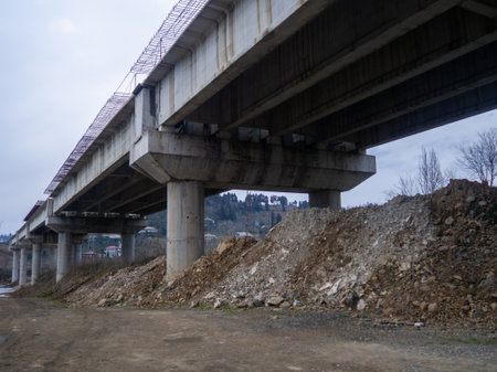 under the overpass. Terrible deserted place. Danger. Gloomy atmosphere. Industrial zone. Autumnの写真素材