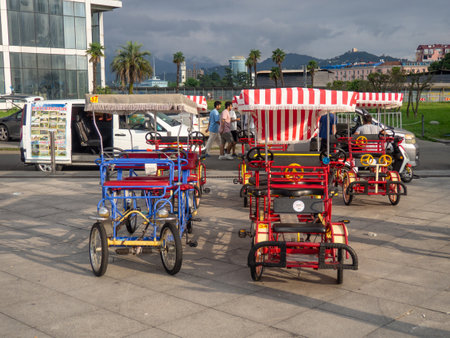 Batumi, Georgia. 08.13.2023 Rent of different bicycles in Batumi. Vacation at the resort. Entertainment option. Local business. Cycle rickshaws. Walk on a wheeled vehicleのeditorial素材