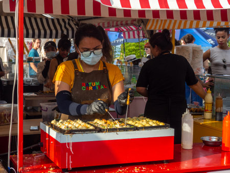 Batumi, Georgia. 08.13.2023 Food stalls at the festival. Cuisines from around the world. Fresh food outside. Mobile tent restaurant.のeditorial素材
