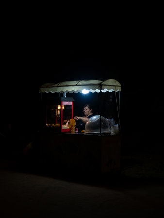 Batumi, Georgia. 08.18.2023  Night city. Business night at the resort. Popcorn vendor. Work overtime. Rest in Batumiのeditorial素材