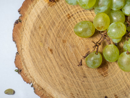 Grapes kishmish on a wooden background. The grapes are overripe. Harvest in the village. wine ingredientの写真素材