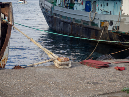 Mooring tied to the bollard. Maritime business. The concept of the ship on the pier. Ship parking. strong knotの写真素材