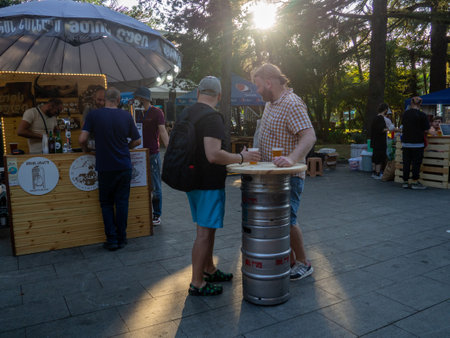 Batumi, Georgia. 08.19.2023  Beer Festival. Tents with draft beer. Foam tasting. People relax and drink. Holiday soft drink. Holiday on the streetのeditorial素材
