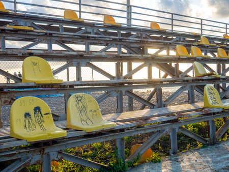 Batumi, Georgia. 09.10.2023 Old broken plastic chairs at the stadium. Abandoned stand at the stadium. Concept of devastation. There are no fans.のeditorial素材