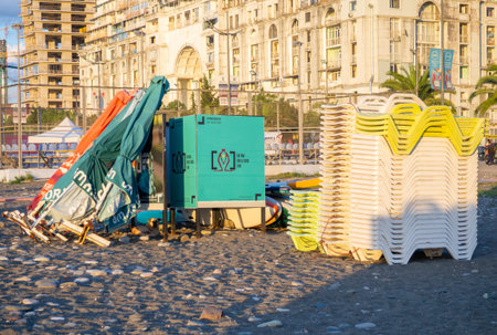 Batumi, Georgia. 09.10.2023 Beach equipment folded. Sunbeds on top of each other. Concept of the end of the beach season. Autumn at sea. Sunsetのeditorial素材