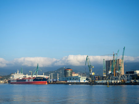 Batumi, Georgia. 09.22.2023 Landscape in the seaport. Port in the Caucasus. Ships and mountains. Clouds over the mountains. Port in Batumi. Logistics. Black Sea cargo transportation industryのeditorial素材