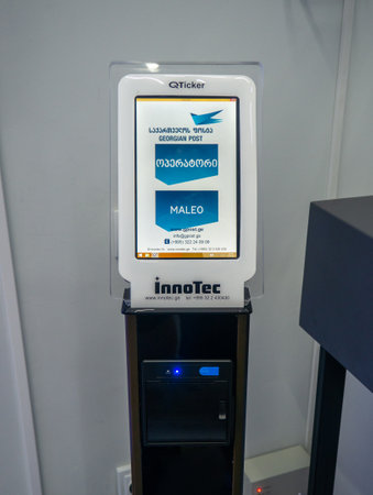 Batumi, Georgia. 09.27.2023 Monitor at the entrance to the Georgian post office. Receive a coupon in line at the post office. Electronic small touch monitor. Services sector. Get a numberのeditorial素材