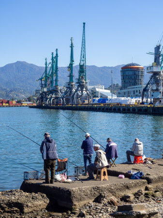 Batumi, Georgia. 10.14.2023 Fishermen in the port of Batumi. Waiting for a peck. People on vacation. Hobbies for people. Day off at the port. Fish catchersのeditorial素材