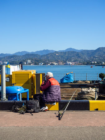 Batumi, Georgia. 10.14.2023 Fishermen in the port of Batumi. Waiting for a peck. People on vacation. Hobbies for people. Day off at the port. Fish catchersのeditorial素材