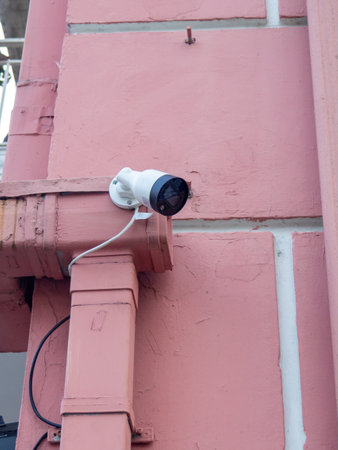 Street surveillance camera. Street surveillance concept. Security. Technologies in the city. Fixed camera on the wallの写真素材