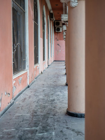 Colonnade in the old town. Corridor near the columns. The architecture and air conditioners are old. Part of the architectural ensembleの写真素材