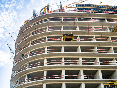 Construction of a modern high-rise building. Sides on the floors. Concrete frame of a building under construction. Cement. Construction in progressの写真素材