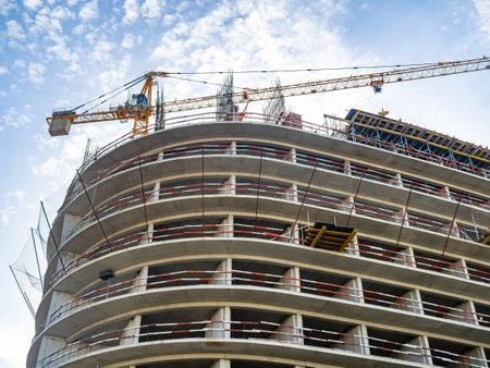 Construction of a modern high-rise building. Sides on the floors. Concrete frame of a building under construction. Cement.Construction in progressの写真素材