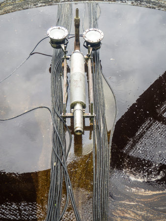 Empty fountain in a city park. Dehumidification. Cleaning the fountain with a hose. The device of...