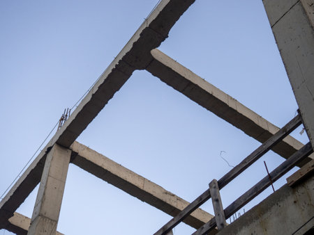 Structure made of concrete piles. Frame of a house under construction. Stone beams. Remains of the buildingの写真素材