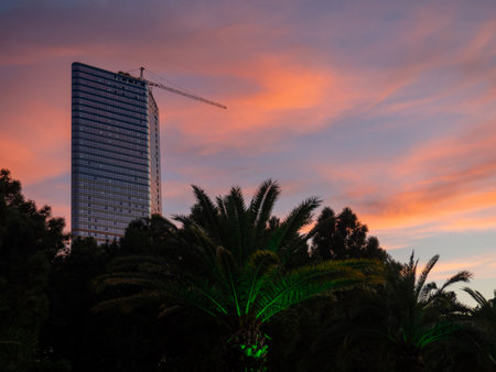 Construction of a multi-storey building against the backdrop of the sunset sky. Construction at the resort. Landscapes of Batumi. A developing place. Construction industry.  Twilightの写真素材