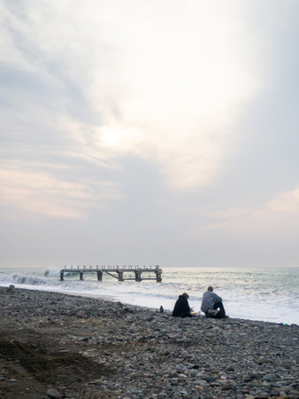 Destroyed pier under the waves. Bad weather at sea. Beautiful seashore with old architecture. Pier on the water in Batumiの写真素材