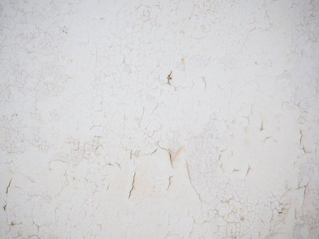 Ceiling of an old apartment. Crumbling plaster. The housing requires renovation. Background made of peel-off coating. Povertyの写真素材