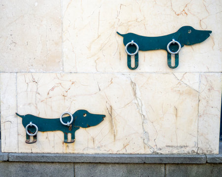 A place for tying a dog leash near the store. Waiting place for the owner's dog. Convenient for dog owners. Rings for attaching a leashの写真素材