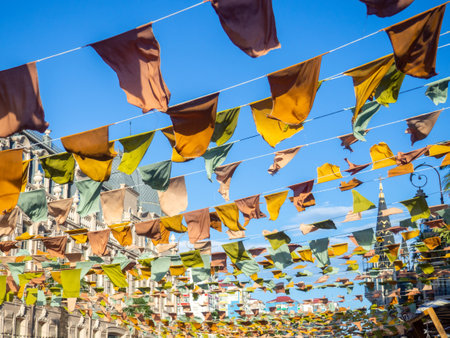 Flags over the street. City celebration concept. Warm colors. Scenery over the street. Festivalの写真素材