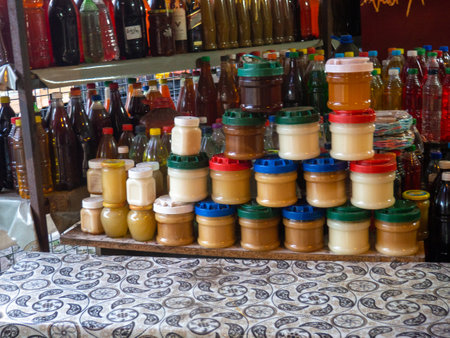 Assortment of honey on the market. Honey in jars on the counter. Lots of products. Asia market conceptの写真素材