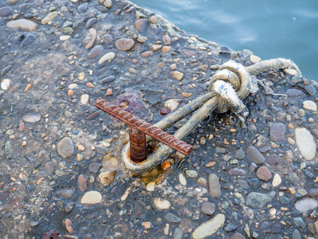Place for attaching a small boat. Fittings for tying the mooring line. Mounting point. Small bollard on the pier. Boat sailing conceptの写真素材