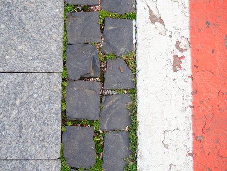 Border between running track and street paving stones. Treadmill concept. Surface for cycling. Infrastructure of a modern city. Backgroundの写真素材
