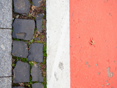 Border between running track and street paving stones. Treadmill concept. Surface for cycling. Infrastructure of a modern city. Backgroundの写真素材