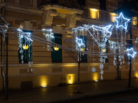 Lights on the street at night. City square on New Year's Day. Garlands for decoration. Holiday symbols.の写真素材