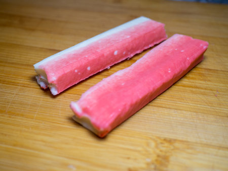 Crab sticks without packaging. Ingredient on cutting board. Fish salad ingredient. Ingredient for salad. Fish appetizerの写真素材