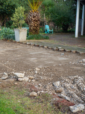 Reconstruction of the bike path. Replacing tiles on a bike path among palm trees. Infrastructure of the resort town. Repair.の写真素材